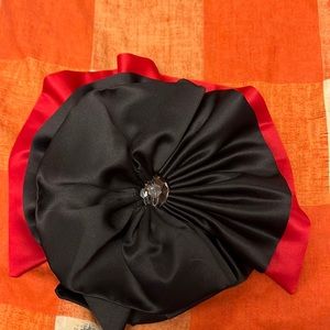 Black and red circular bow that can be worn on many occasions.